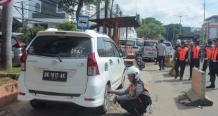Petugas Dishub Palembang mengempisi ban mobil yang parkir sembarangan, Selasa (16/1/2024). Foto: Sumselheadline/Pitria.