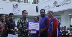 Pj Walikota Palembang, Ratu Dewa memeberikan bonis pada para Porprov Lahat, Kamis (4/4/2024). Foto: Kominfo Palembang.