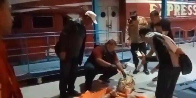 Polisi dan warga mengevakuasi mayat yang ditemukan terikat rantai besi di Sungai Musi, Rabu (19/6/2024). Foto: Sumselheadline/Ela.