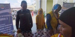 Aipda Muhammad Aliudin yang ikut membagikan minuman di masjid. Foto: Sumselheadline/Ela.