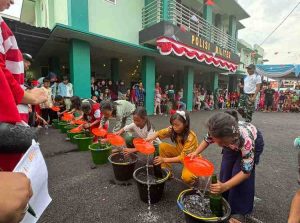 Anak-anak antusias ikut lomba memasukkan air dalam botol di halaman subdenpom, Sekayu, Minggu (188/2024). Foto: Kominfo Muba.