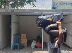 Tampak seorang pedagang Pasar 16 Ilir Palembang mulai mengangkut barang dagangan ke los sementara, Selasa (17/9/2024). Foto: Sumselheadline/Pitria.