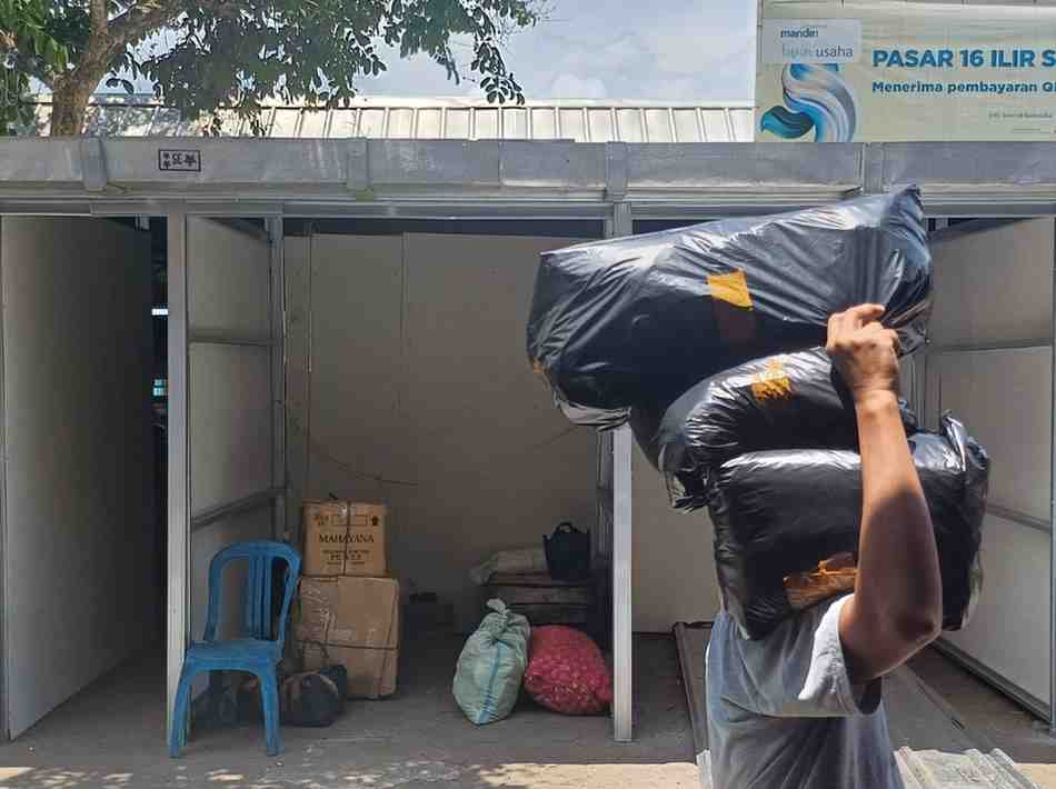 Tampak seorang pedagang Pasar 16 Ilir Palembang mulai mengangkut barang dagangan ke los sementara, Selasa (17/9/2024). Foto: Sumselheadline/Pitria.