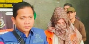 Salah satu tersangka (baju orange) dalam kasus penerbitan sertifikat PTSL BPN Kota Palembang. Foto: Dok Sumselheadline.