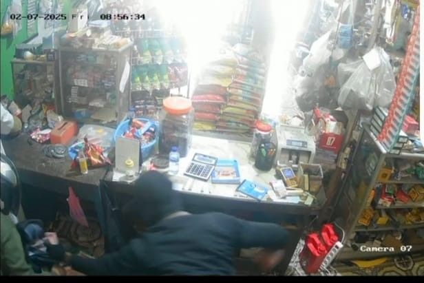 Dua kawanan rampok memasukkan kepokan uang ke dalam kantong, yang diambil dari laci korbvan Mery di Desa Keban 1 Sanga Desa, Muba. Foto: sceenshot video CCTV.