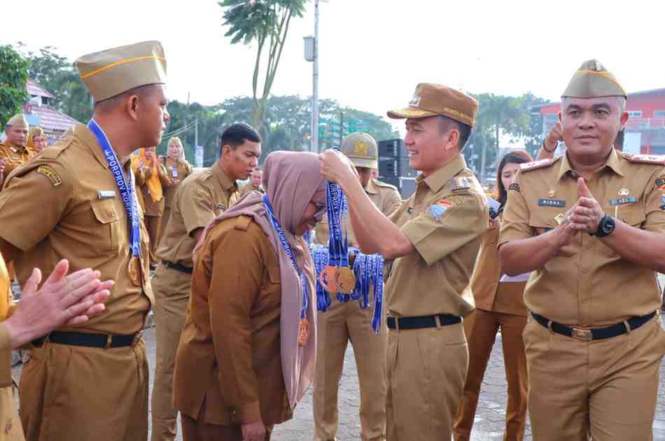 Walikota Palembang, Ratu Dewa mengalungkan medali pada salah satu atlet Porprov Korpri di momen ape bersama di pelataran BKB, Senin (7/7/2025). Foto: Kominfo Palembang.