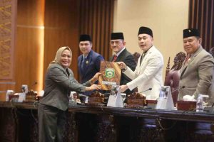 Juru bicara Fraksi Golkar DPRD Sumsel At Thahirah Putri Lestari menyerahkan berkas pandangan fraksi kepada pimpinan rapat Nopianto, MM, JUmat (11/7/2025). Foto: Humas Pemprov Sumsel.