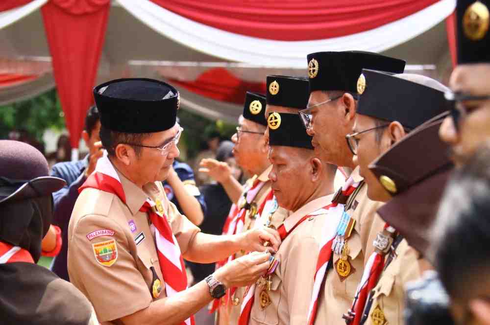 Kamabicab Gerakan Pramuka Kota Palembang, Rayu Dewa menyematkan penghargaan kepada sjeumlah pengurus Pramuka, Sabtu (30/8/2025). Foto: Kominfo Palembang.