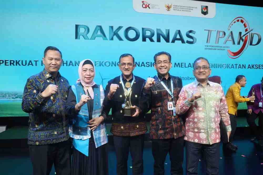 Sekda Sumsel, Edward Candra menerima piala Sumsel sebagai Provinsi Terbaik TPAKD Award 2025 tingkat wilayah Sumatera oleh OJK RI, Jumat (10/10/2025). Foto: Humas Pemprov Sumsel.