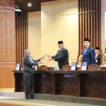 Sekda Sumsel, Edward Chandra menerima berkas pandangan fraksi terhadap LPJ Gubernur Sumsel akan pelaksanaan APBD Sumsel 2025 pada rapat paripurna DPRD Sumsel, Jumat (26/6/2026). Foto: Humas Pemprov Sumsel.